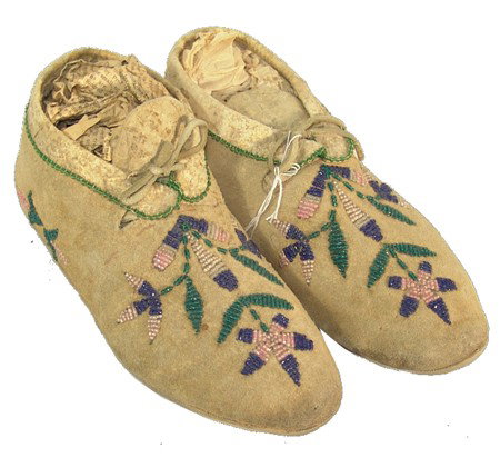Cree Beaded Moccasins: Classic pair of buckskin moccasins with hard soles and traditional floral beadwork. Very good condition. Circa: 1940s Size: 9-3/4" long