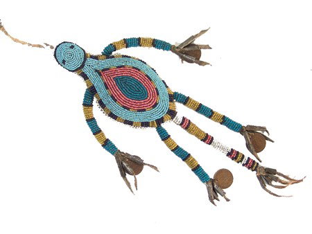 Plains Beaded Fetish: Beautifully beaded Sioux style umbilical amulet done in lizard(?) form. The long appendages with tin cone and/or Indian head pennies. Excellent condition. Circa:Late 1900s Size:Body 5" x 2-1/2"
