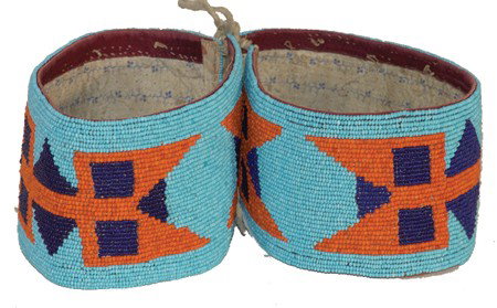 Crow Beaded Arm Bands: Classic pair of fully flat beaded arm bands with large geometric symbols on a light blue field. Circa:Mid 1900s Size:Each 11-1/2" x 3"