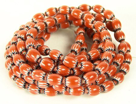 Chevron Trade Beads: Circa Late 1900s, 3 strands of colorful 5-layer small chevron trade beads in orange. Excellent condition. 30" long