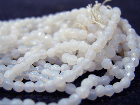 Antique Trade Beads: Circa Early-mid 1900s, Bagged collection of faceted white milk glass Czech beads on original hanks. 1/4" each