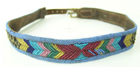 Nez Perce Beaded Belt: Traditional hard leather belt beaded with cut beads and decorated with brass tacks, a very interesting design. Three rows of beads missing plus a few on the edging, otherwise good condition. 33" long