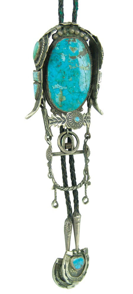 Navajo Bolo Tie: Circa Mid 1900s, Very unique handcrafted bolo in the form of a bridle with straps , rosettes, bits, buckle, etc. and custom horseshoe tips. Very good condition except the large stone is cracked. 6" x 