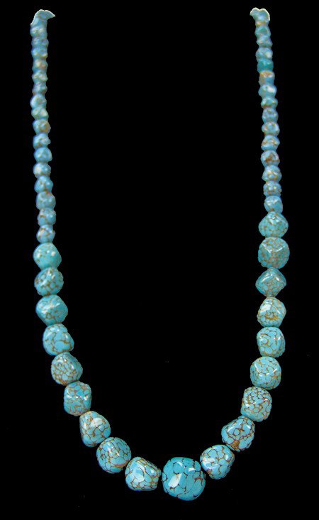 Tradebead Necklace: Circa Mid-late 1900s, Beautiful strand of graduated faceted Hubble style turquoise colored beads with gold/yellow spider matrix. Excellent condition. 24" long, 5/8" largest bead