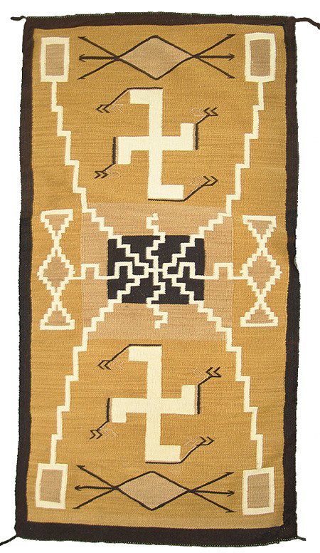 Navajo Rug/Weaving: Circa 1930s, Very rare gold background storm pattern pictorial rug with large fylfot crosses, corn plant symbols, arrows, etc. Very good well used condition, possibly some minor edge repairs. 60" x 31