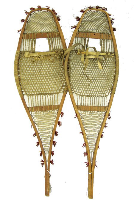 Winnebago Snowshoes: Circa 1900s, Great pair of bentwood snowshoes with intricately woven rawhide webbing and remnants of the original red wool tufts around the edges. Very good condition. 33" long