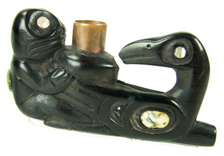 Tlingit Carved Pipe: Circa Late 1900s, Outstanding hand carved two-figure short pipe with copper bowl and abalone inlay features. Very good condition, made from stone-like lignum vitae, the world's hardest, densest wood.