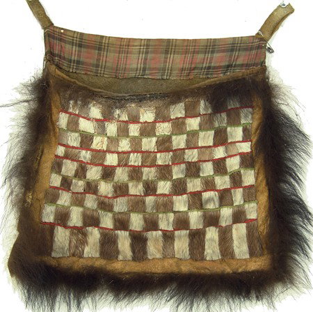 Athbascan Sled Bag: Circa Early 1900s, Rare patchwork sealskin, bear hide, and moose hide flap bag used to hang from a sled. Very good condition. 12-1/2" x 12"