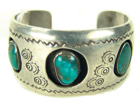 Navajo Bracelet: Circa 1970s, Classic shadowbox design all silver hollowwork bracelet set with three aged turquoise stones. Very good used condition. 5-1/2" x 1-1/4" + 1-1/4" gap