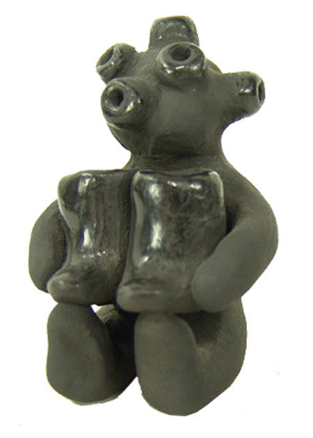 Santa Clara Figure - Dorothy & Paul Gutierrez, Sr.: 1980s, Whimsical small blackware seated mudhead figure holding his boots. Very good condition. 3" x 2"