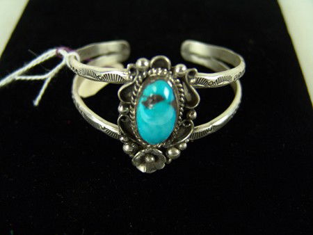 Navajo Bracelet - Kenneth Begay: Late 1900s, Classic Navajo single stone turquoise and silver bracelet in very good condition by Kenneth Begay. 5-1/4" x 1-1/2" + 3/4" gap