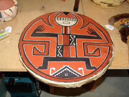 Figural Gaming Drum: 1960s, Colorful hand crafted Pueblo wooden ring drum with painted rawhide face. Good condition, warped, better as a wall hanger. 2" x 17"