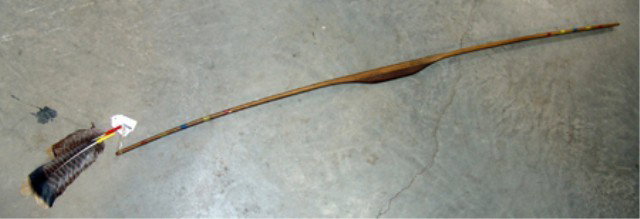 Native Bow: Painted wood bow with feathers.