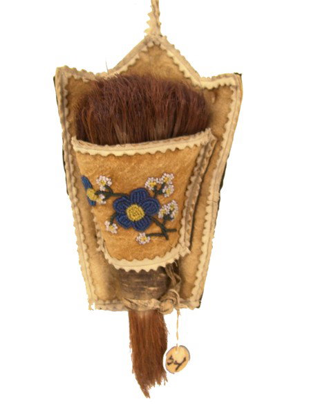 Athabascan Brush: Rare rawhide wrapped plant fiber brush used for cleaning baskets. Comes with beaded moosehide holder. Very good condition. Circa: Early 1900s Size: 8" x 5"