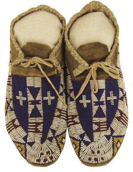 Arapaho Beaded Moccasins: Early 1900s, Exceptional pair of sinew sewn and lazy stitch beaded elk hide moccasins with hard buffalo rawhide soles and rare crosses in the design. Very good condition, beautiful visual appeal. 10"