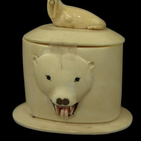 Eskimo Ivory Carving: Mid 1900s, Well executed lidded matchbox with polar bear carved in the face and a walrus on the lid as the handle. Very good condition. 3" x 3"