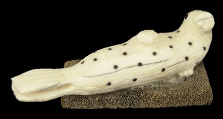 Eskimo Ivory Carving: 1970s, Fine ivory carving of a rare leopard seal, the spots of inlaid baleen. Very good condition. 1" x 5"