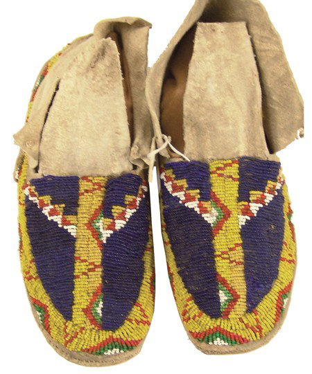 Cheyenne Beaded Moccasins: Early 1900s, Traditional pair of sinew sewn and lazy stitch beaded elk hide moccasins with hard rawhide soles and traditional designs. Very good condition, just a few missing beads. 10"