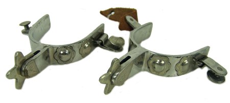 Crockett Spurs: Beautiful pair of stainless steel spurs with engraved German silver appliques and soft 5-point rowels. Marked "Crockett" and "Stainless". Size: 3-1/2" x 5" ea. Circa: Late 1900s