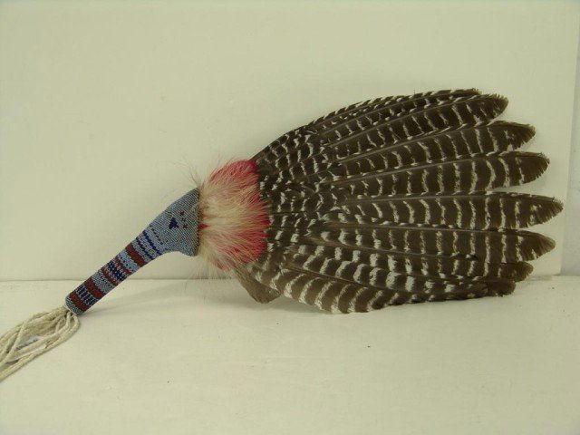 Sioux Dance Fan: Large Sioux beaded feather dance fan with peyote stitched handle and braided fringe. Very good condition. Circa: 1970s Size: 20" x 8"