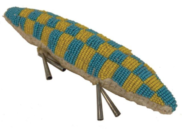 Crow Beaded Fetish: Traditional style lazy stitch beaded umbilical cord fetish with tine cone "legs". Very good condition. Circa: Late 1900s Size: 1 1/2" x 7"