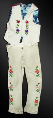 Crow Buckskin Vest and Pants: White beaded buckskin man's vest with beaded floral design with accompanying heavy buckskin pants. Very good condition. Circa 1970s. Size Men's large, 38" x 35". Size: Men's L/XL