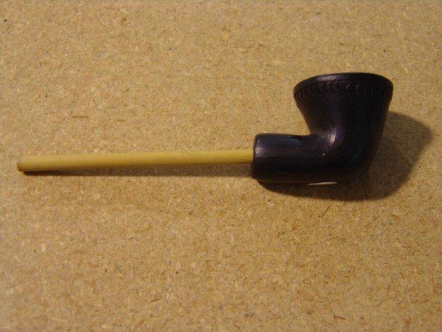 Black Pipe Bowl: Handcrafted black clay pipe with bamboo stem. Circa: Mid to late 1900s Size: 6-1/2" x 1-1/2"