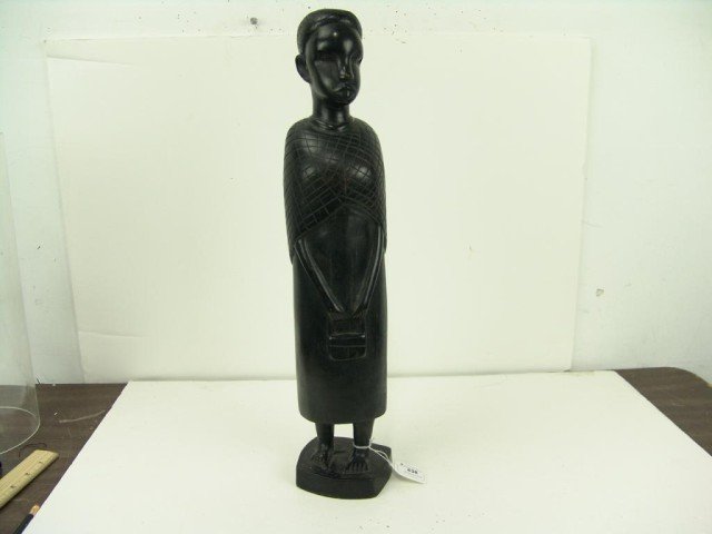 African Wood Carving: Large ebony statue of a female holding a purse. Tanzania. Circa: 1970s Size: 20" x 5"