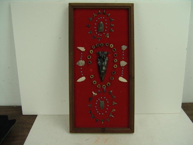 Arrowhead Frame: Large framed artifact display of shark teeth, milifiore beads, and a large obsidian blade. Circa: 1970 Size: 21" x 10"