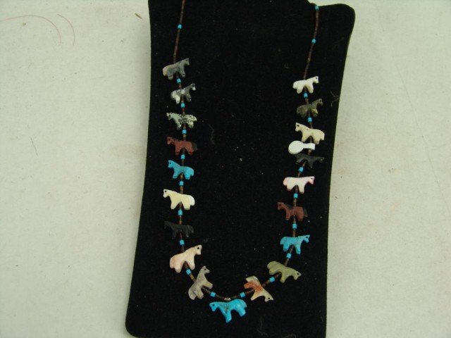 Fetish Necklace: Beautiful hand carved horse fetish necklace with jet, spondulus, soapstone, and other on heshi. Size: 28" long