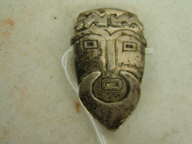 Silver Pin: Hand stamped silver portrait pin showing a man with lighting bolts on his head. Very good condition, nice patina. Size: 2" x 1"