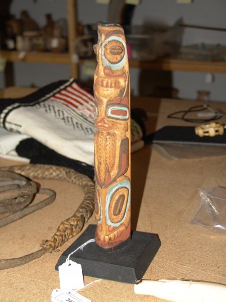 Northwest Coast Model Totem Pole - Yeltatzie: Early hand carved and painted yellow cedar totem pole with concave back and triangular shape. Very good used condition, Hydaburg, AK. Circa: Early 1900s Size: 12" x 2" x 2" + base