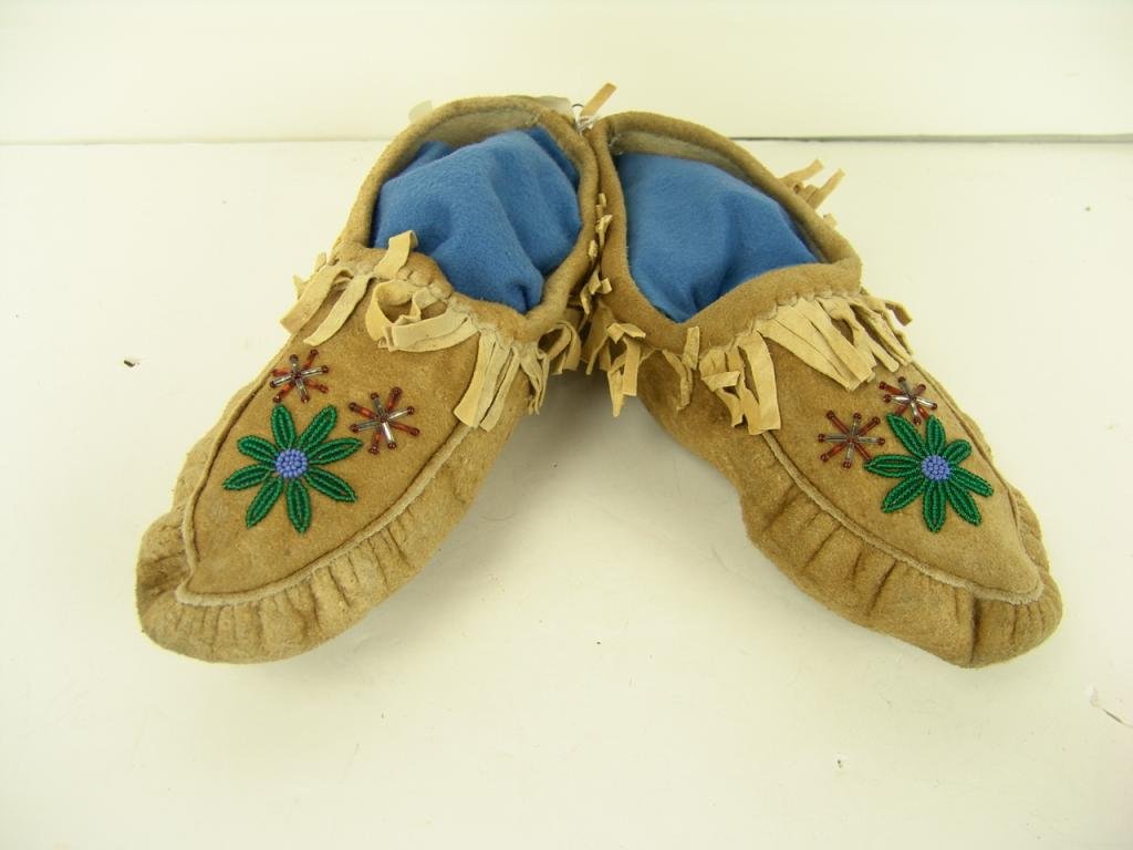 Beaded Moccasins: Athabascan Moose hide moccasins with beaded flowers on the toes. Very good condition. Attached tag says "Purch. Sept 14, 1963 Whitehorse, Yukon Territory." Circa: 1960s Size: 10-3/4"