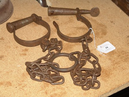 Leg Irons: Pair of working heavy iron leg irons, working condition with key. Very good condition. Size: 4" x 5" each iron