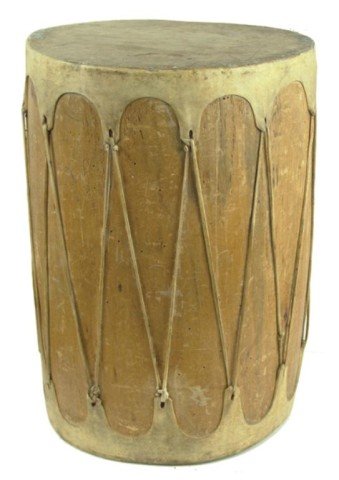 Taos Barrel Drum: Large hand carved cottonwood log drum with rawhide faces and lacing. Very good condition, one broken lace but still intact and usable. Circa: 1950s Size: 20-1/2" x 13-1/2"