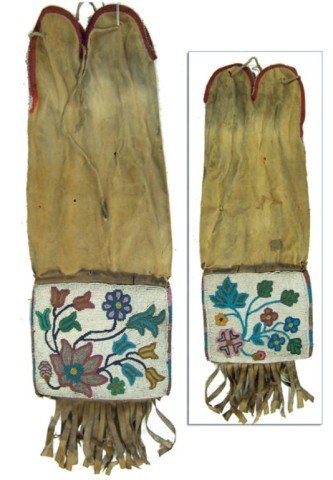 Cree Beaded Pipe Bag: Great old 2-sided contour beaded bag with tabbed top, fringed bottom, and exceptional floral design beadwork. Good condition, buckskin split and torn in a few places. Circa: Late 1800s Size: 19" x 7"