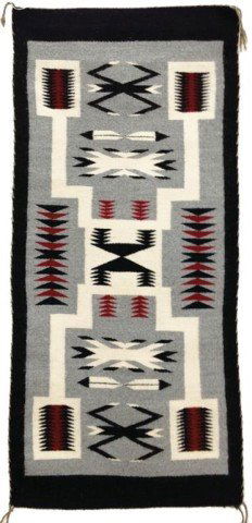 Navajo Rug/Weaving: Classic Navajo storm pattern rug with feathers and water bugs on gray ground and with black border using home spun wool. Excellent condition. Circa: Late 1900s Size: 45" x 20"