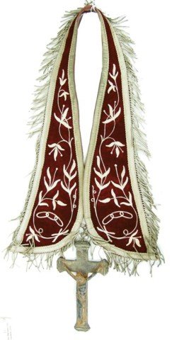 Vintage Crucifix: A rare old cast iron(?) corpus and cross hung on an early 1900s embroidered and ribbon trimmed velvet vestment sash. Very good condition. Circa: Various Size: 8" x 4" Crucifix, 40" x 4" Sash