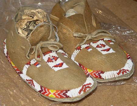 Kickapoo Moccasins: A pair of Kickapoo beaded moccasins with hard soles, done in moose hide. 10
