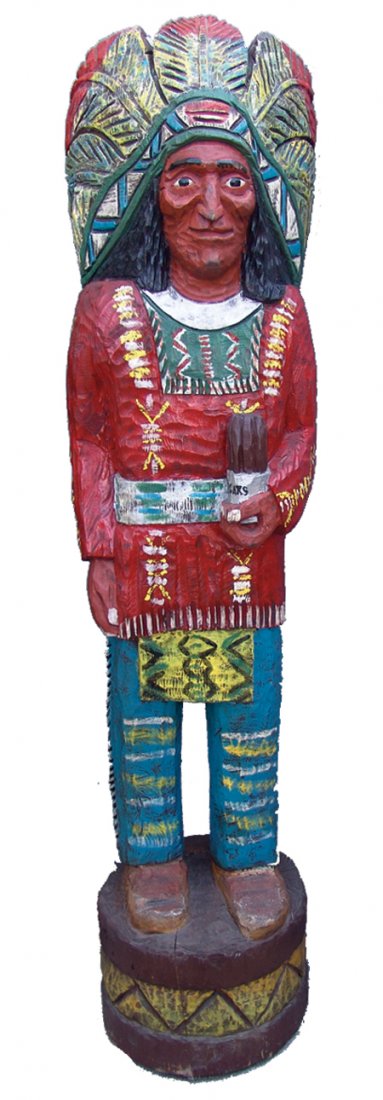 Cigar Store Indian Carving: Mid 1900s, Vintage, hand carved and painted "Cigar Store Indian" carving done in traditional style, with full headdress and many details, shown holding a jar of cigars. Very good condition, was always