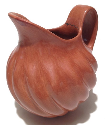 Jemez Pottery Pitcher - Juanita Fragua: Ca. 1984, Excellent redware pitcher with squash design and signature arrow on handle. Hallmarked. 7-1/2" x 6"