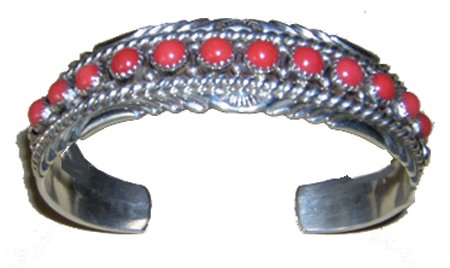 Navajo Bracelet - Marie Thompson: Ca. 1980s, Very fine sterling silver bracelet with 12 round red coral stones, marked "M." Very good condition. 6-3/4" + 1-1/4" x 3/4"