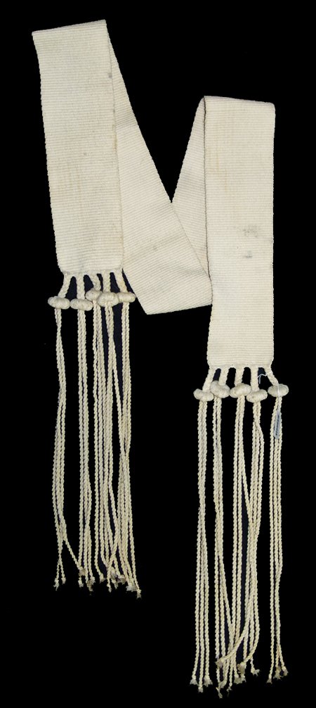 Hopi Rain Sash: Mid 1900s, Traditional hand woven white wool dance sash with twist fringes and balls traditionally filled with cornmeal. Very good condition, with light soiling. 68" x 4-1/2" + fringe