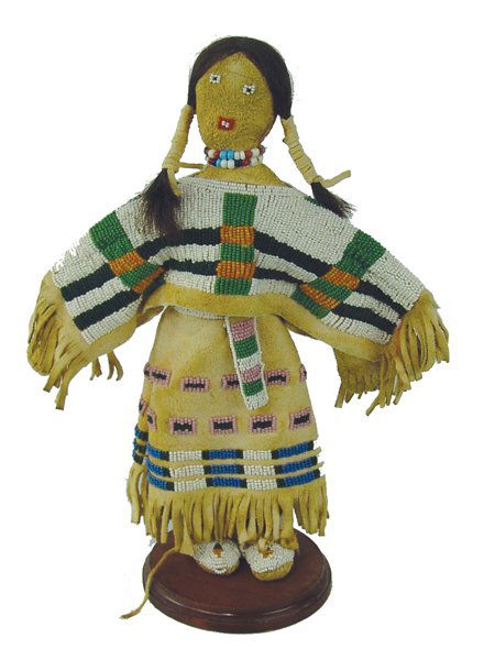 Beaded Buckskin Doll: Late 1900s, Beautiful hand crafted Cheyenne-style beaded buckskin doll with moccasins, dress, full yoke, belt, and human hair. Very good condition. 12"