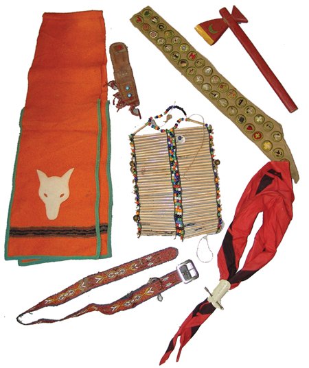 Vintage Boy Scout Apparel: Various, Orange wool breechclout with wolf figure, knife sheath, a merit badge sash, a neckerchief with slide, a wooden tomahawk, a beaded belt in poor condition, and a great bone and bead breast plat