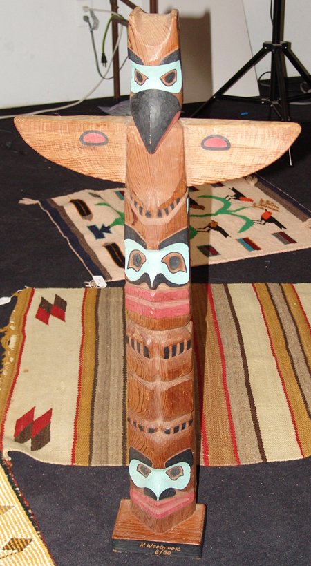 NW Coast Totem Pole - K. Woodcock: 1980, Classic hand carved and painted red cedar 3-figure totem pole on base with extended wings. Very good condition. 34" x 17" x 4" + base