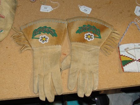 Cree Beaded Gauntlets: Mid 1900s, Traditional pair of Cree or Plateau moose hide gloves, with uppers containing simple beaded leaves and flowers. Very good condition. Woman's S/M