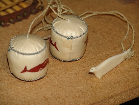 Eskimo Toy: 1980s, Traditional hand crafted sealskin balls with applique figures and string with carved bone handle. "Eskimo Yo-Yo's". Very good condition. 2" x 2" each