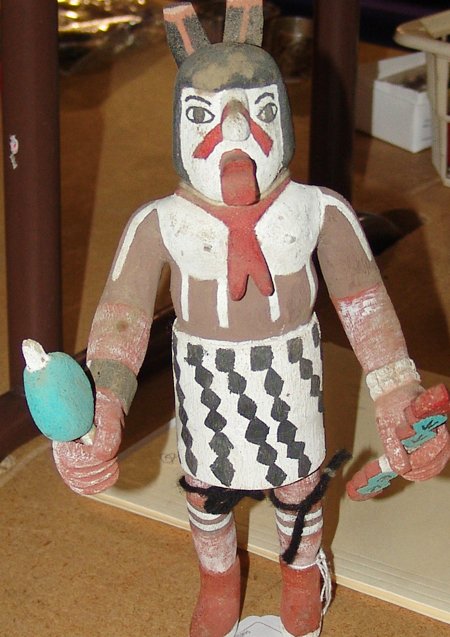 Hopi Katsina Carving: Rare cross legged hand carved and painted kachina with dance wand and rattle. These were commonly given to children from the kachinas as gifts. Good condition with minor blemishes. 11"