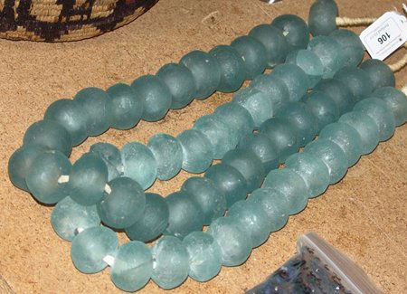 Antique Tradebeads: Early 1900s, Two matching strands of extra large transparent sea glass tradebeads. Very good condition. 31" Each